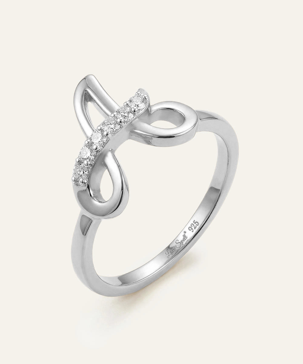 Silver ring with diamond accents on a white background