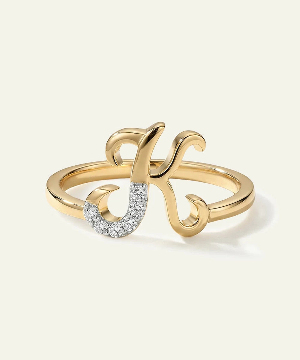 Gold ring with a decorative design on a white background