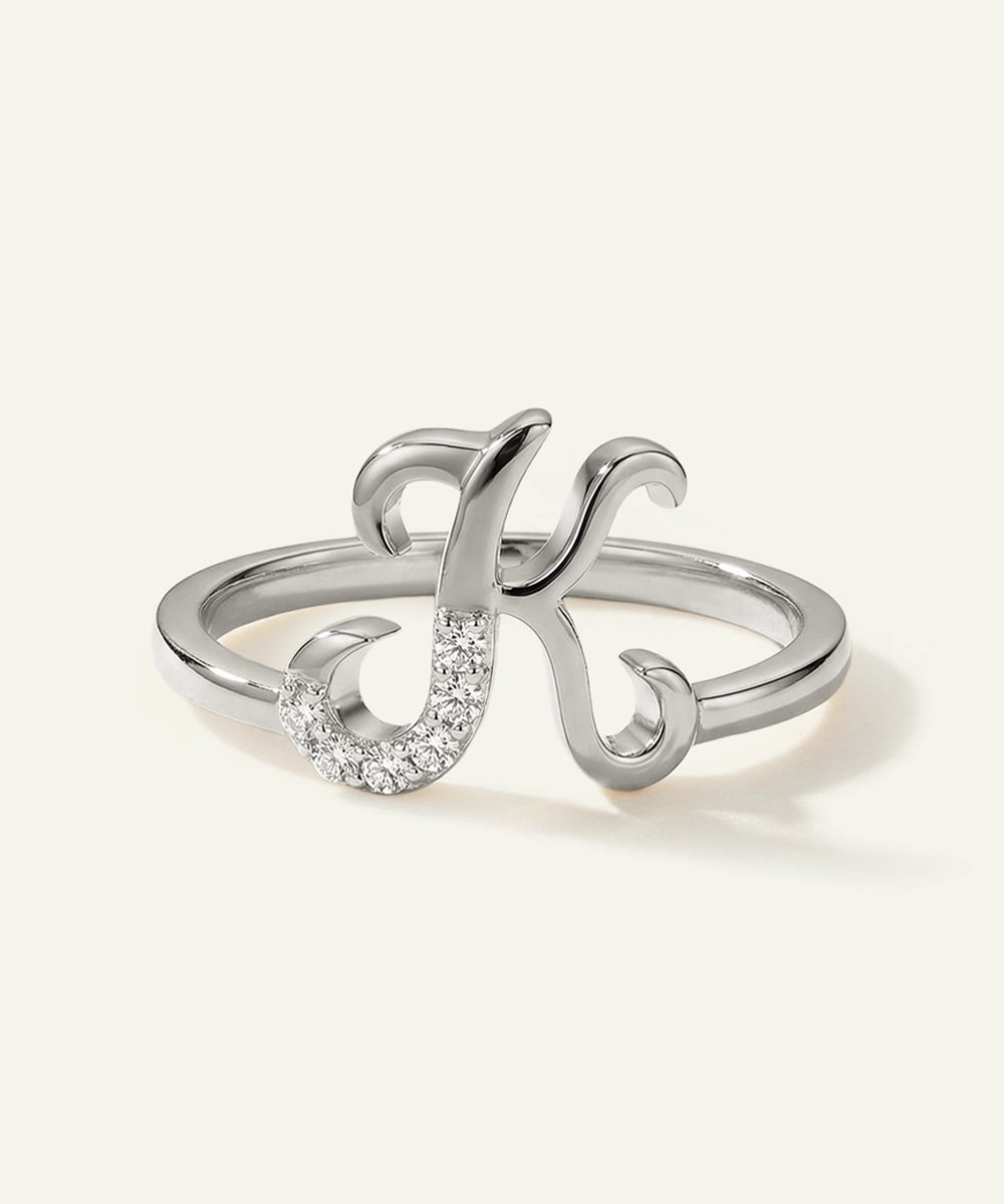 Silver ring with a decorative design on a white background