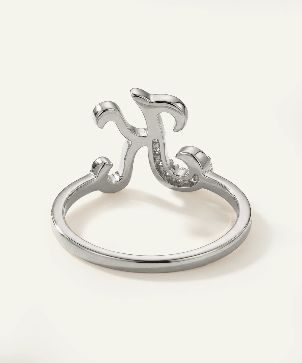 Silver ring with decorative design on a white background