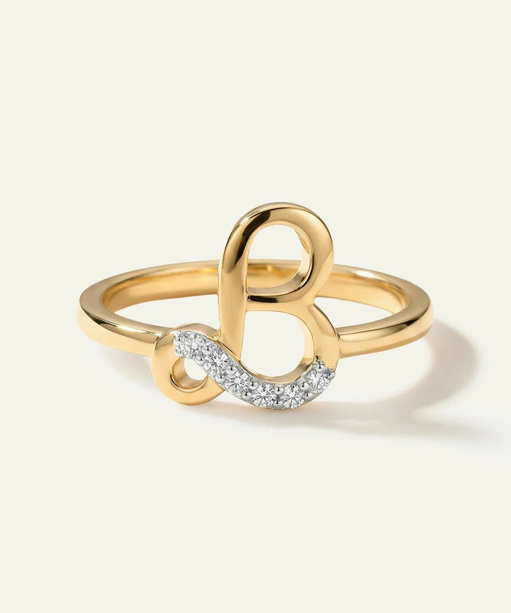 Gold ring with a unique design on a light beige background
