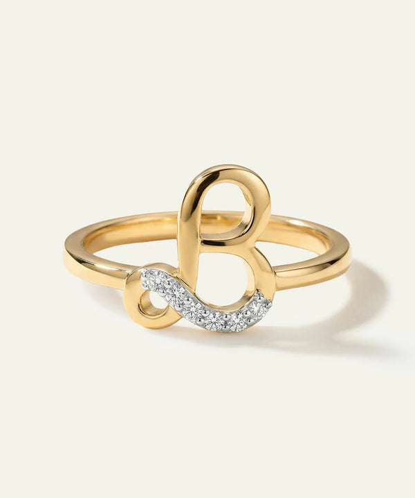Gold ring with a unique design on a light beige background