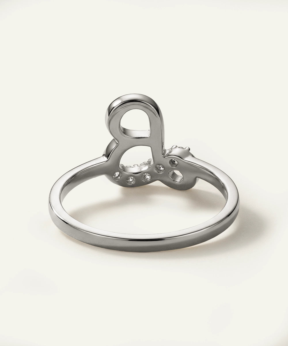 Silver ring with heart design on a white background