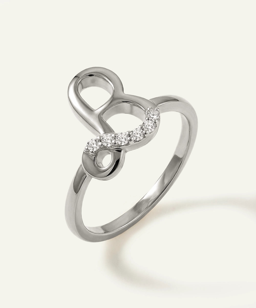 Silver ring with a heart and infinity symbol design on a white background