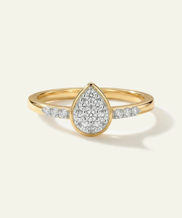 Gold ring with a teardrop-shaped diamond design on a white background