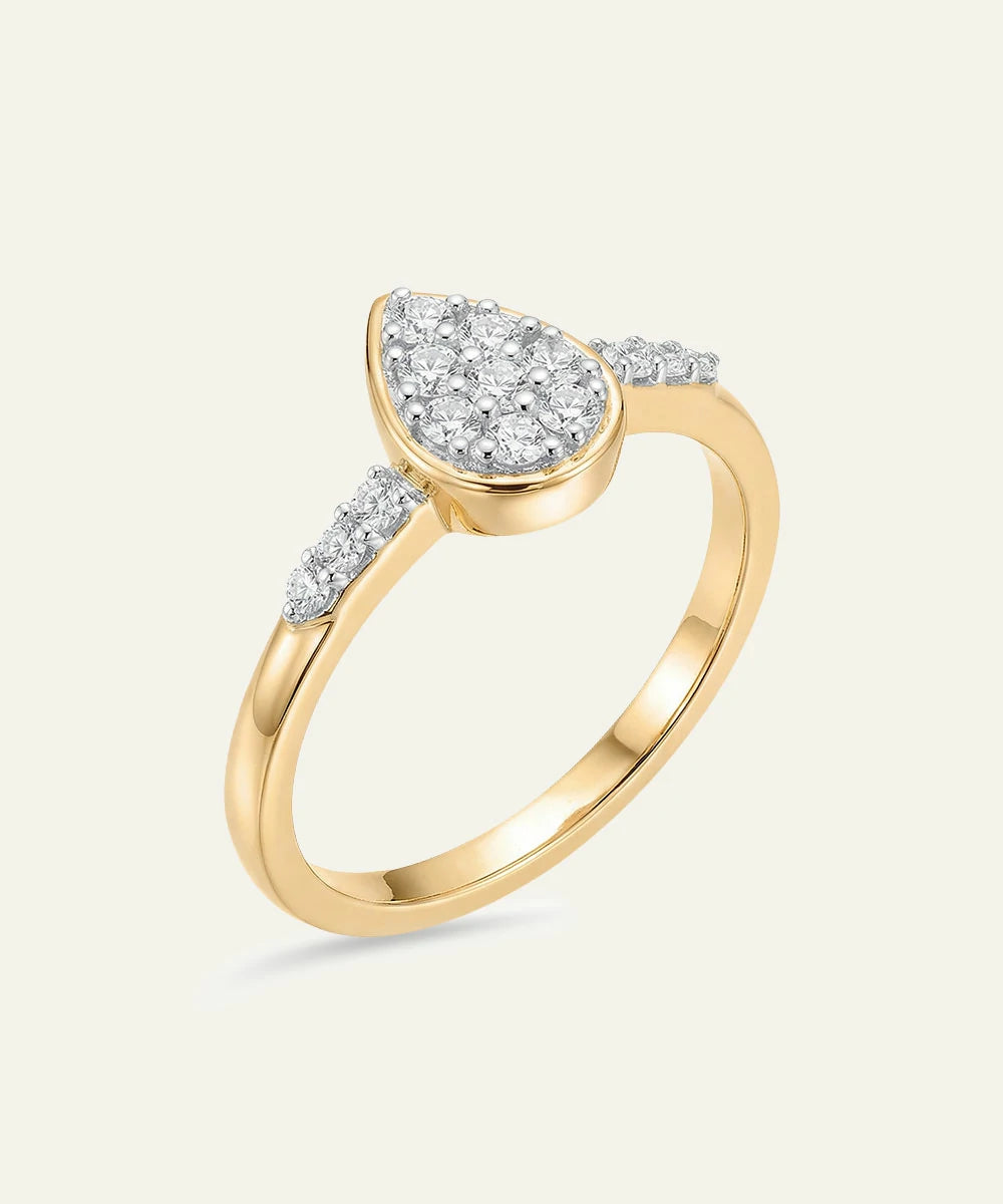 Gold ring with diamond accents on a light beige background