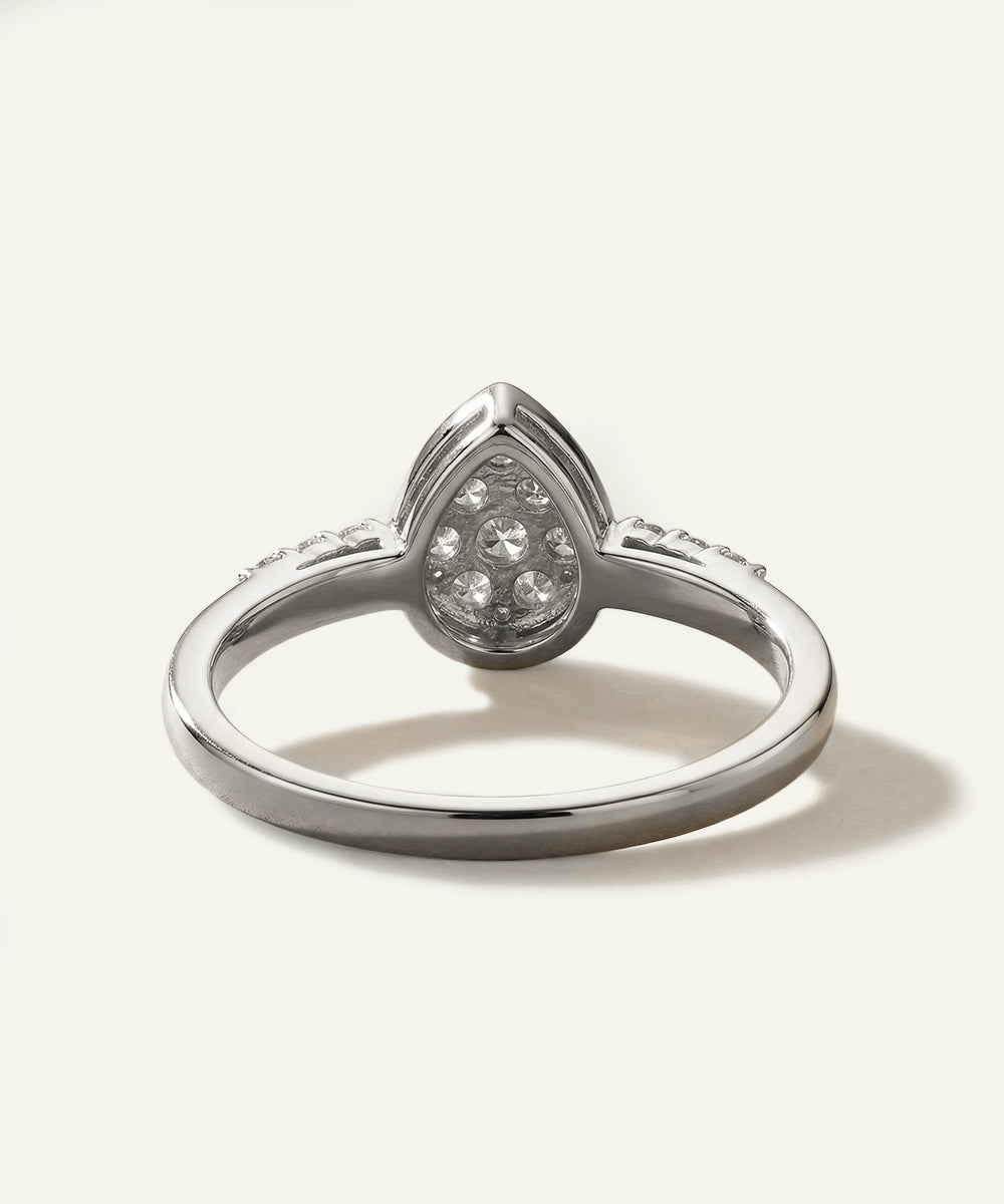 Silver ring with a teardrop-shaped diamond on a white background