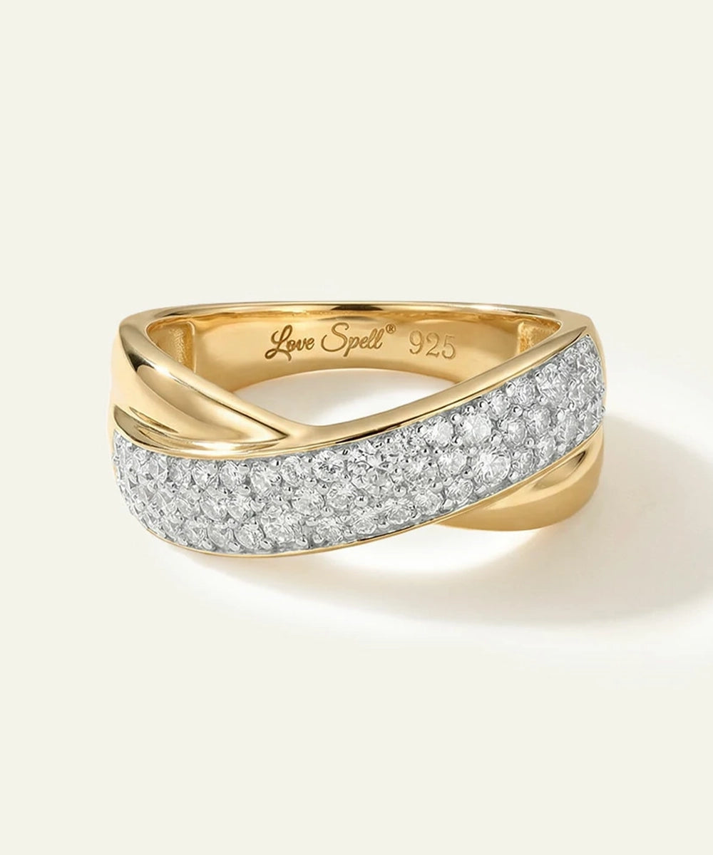 Gold ring with diamond accents on a light beige background