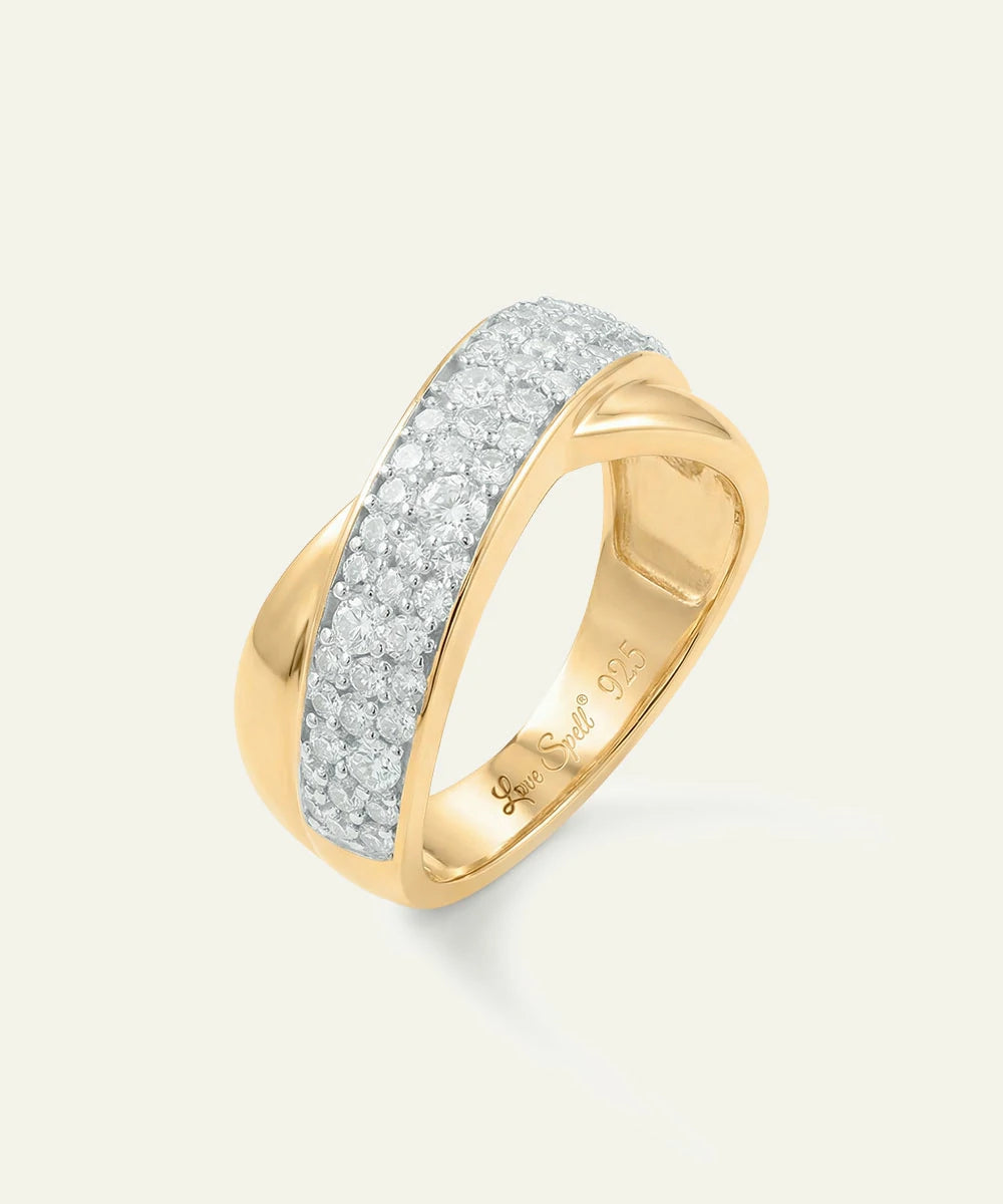 Gold ring with diamond accents on a light gray background
