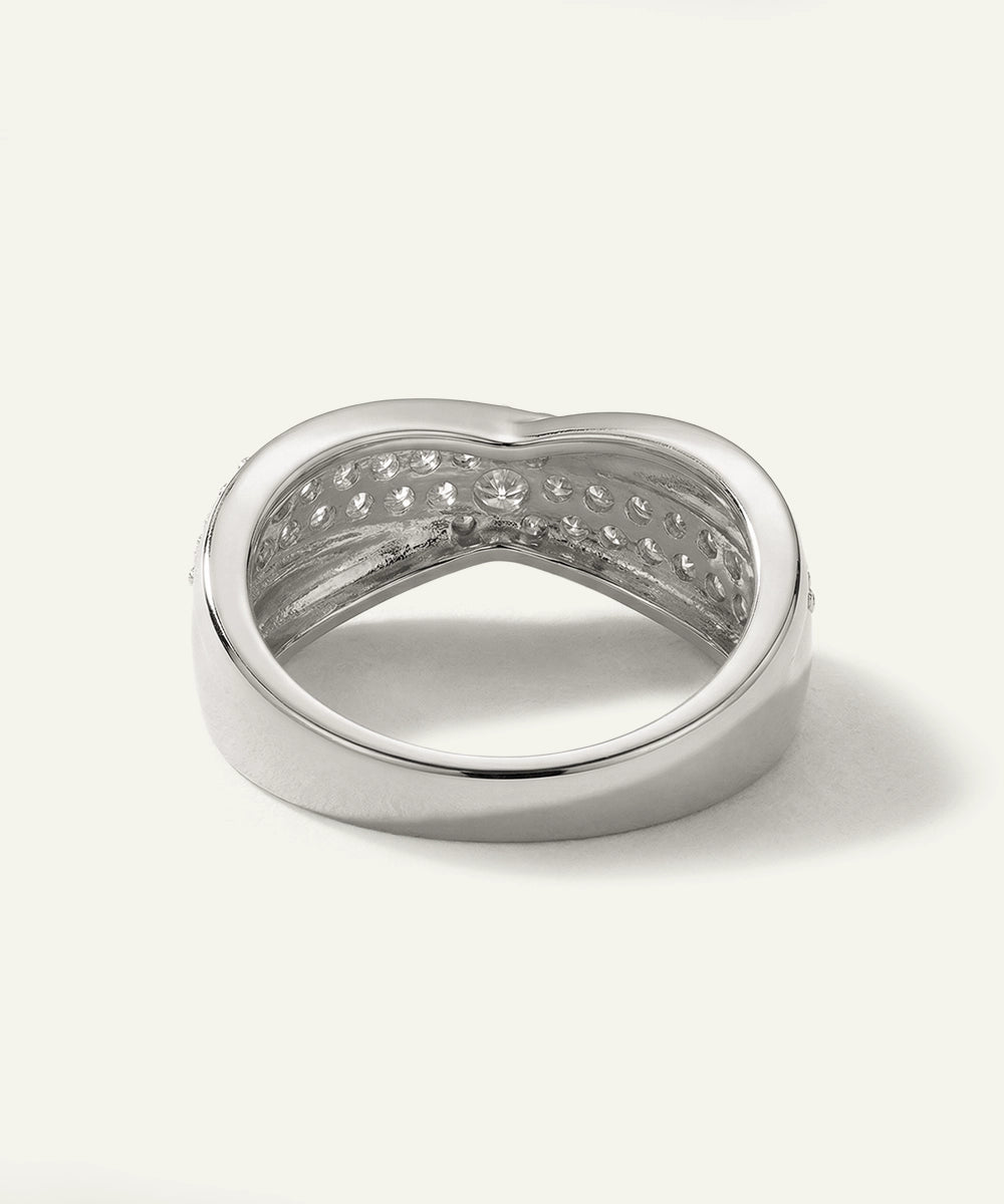 Silver ring with embedded stones on a white background