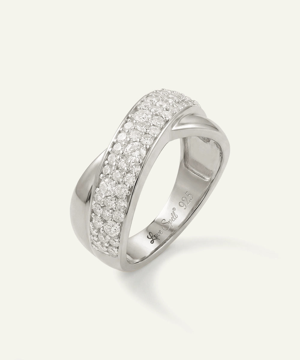 Silver ring with diamond accents on a white background