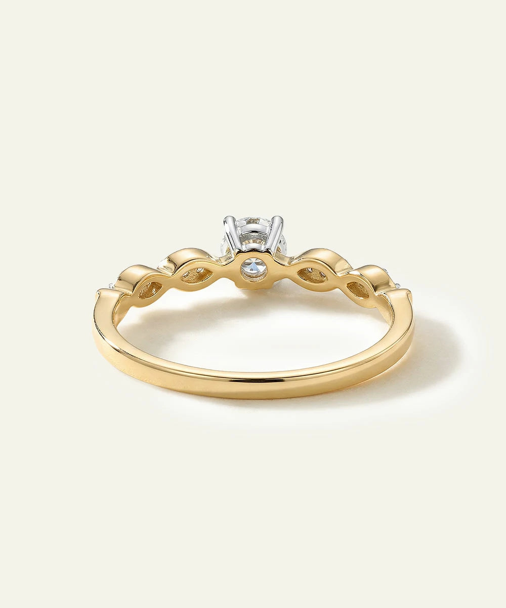 Gold ring with a diamond on a light beige background