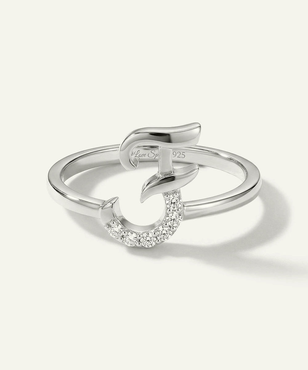 Silver ring with a small diamond on a white background