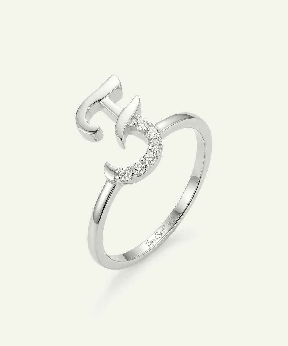 Silver ring with a unique design on a white background