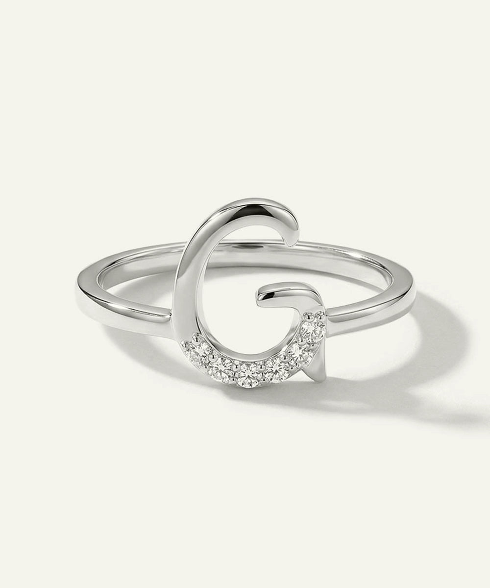 Silver ring with a crescent moon design on a white background