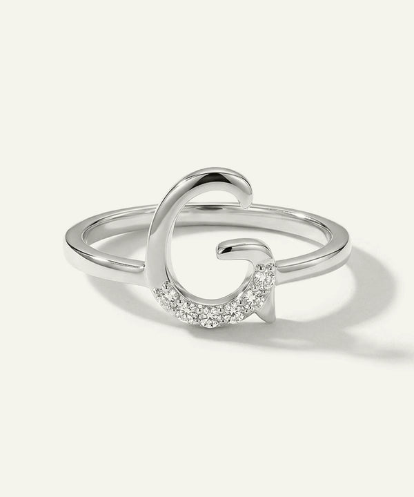 Silver ring with a crescent moon design on a white background