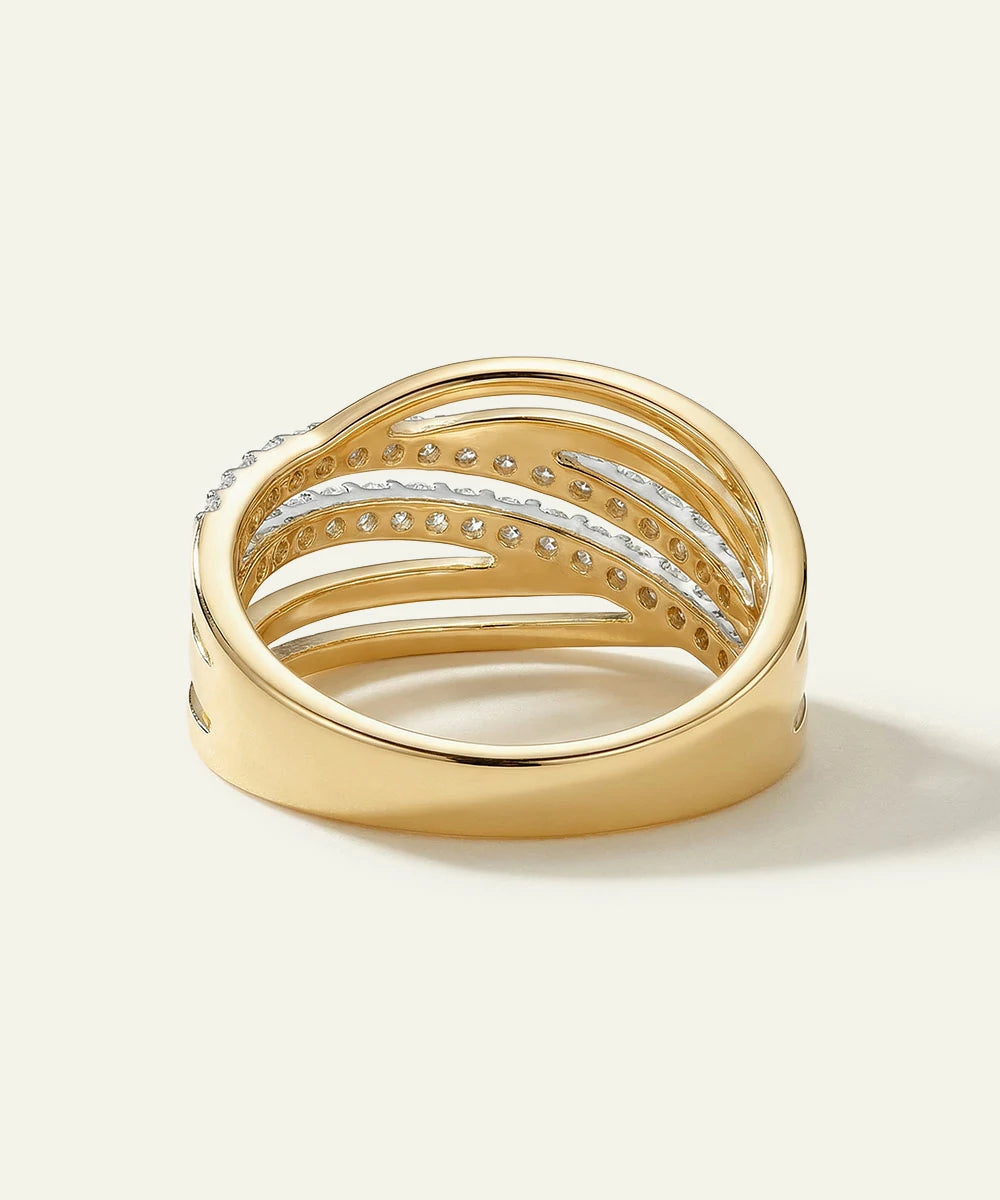 Gold ring with diamond accents on a light background