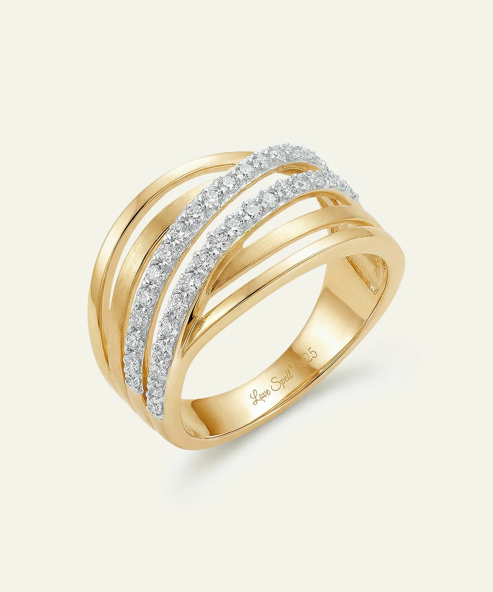 Gold ring with diamond accents on a light gray background