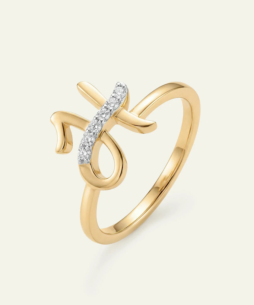 Gold ring with diamond accents on a light beige background