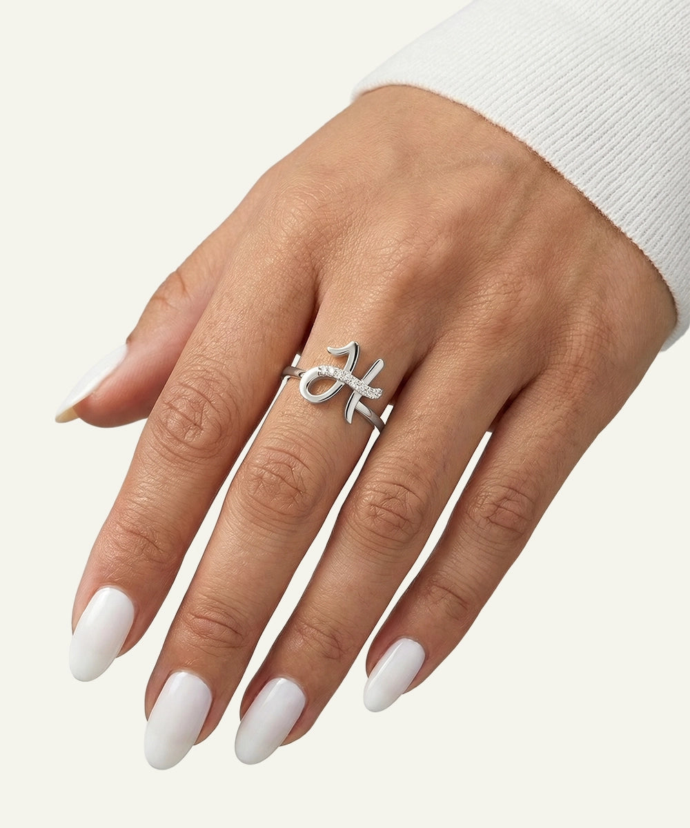 Hand wearing a silver ring with a white background