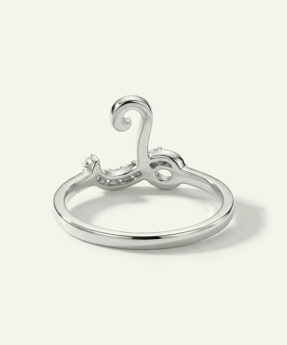 Silver ring with a decorative design on a white background