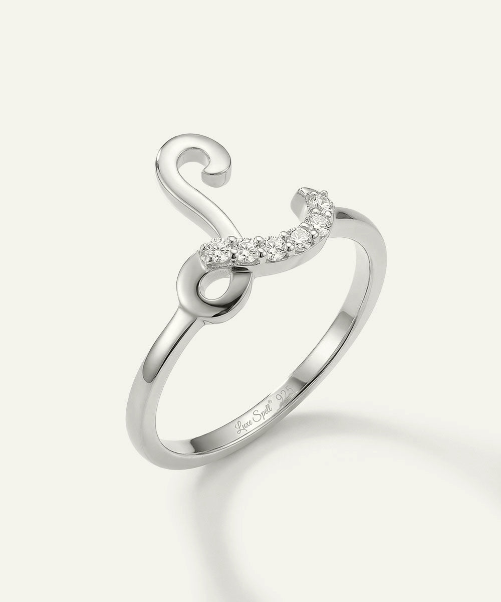 Silver ring with a crescent moon design on a light gray background