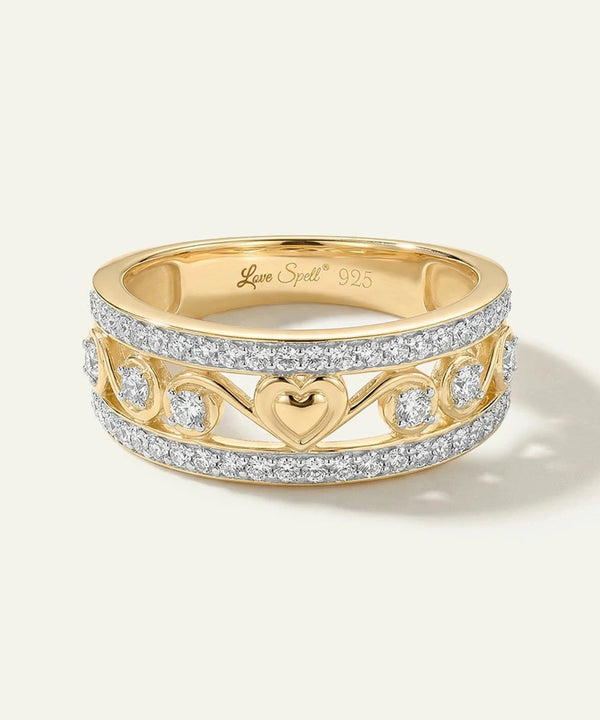 Gold ring with heart design and diamonds on a white background