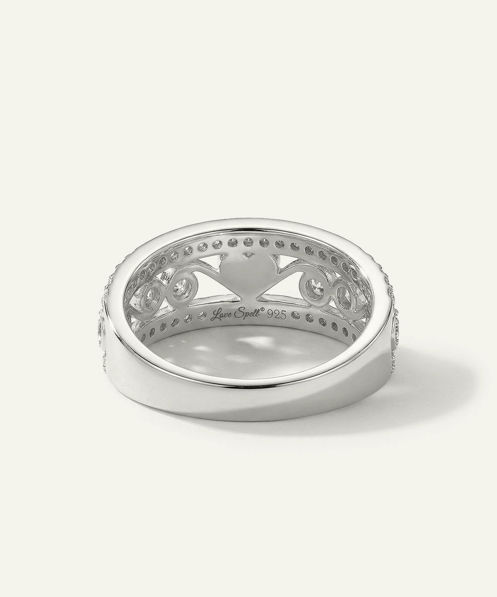 Silver ring with intricate design on a white background