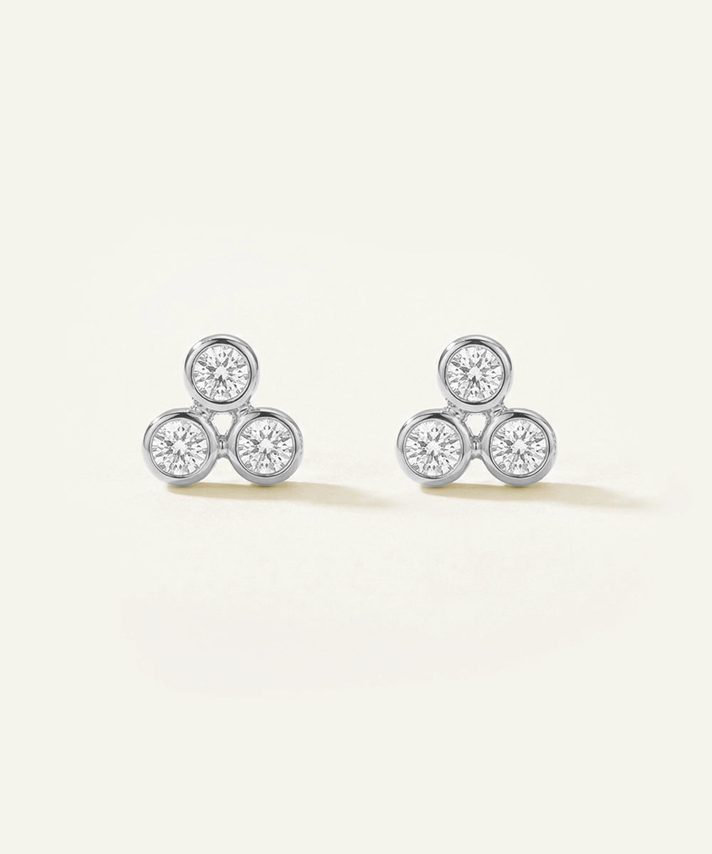 Pair of diamond stud earrings on a light background