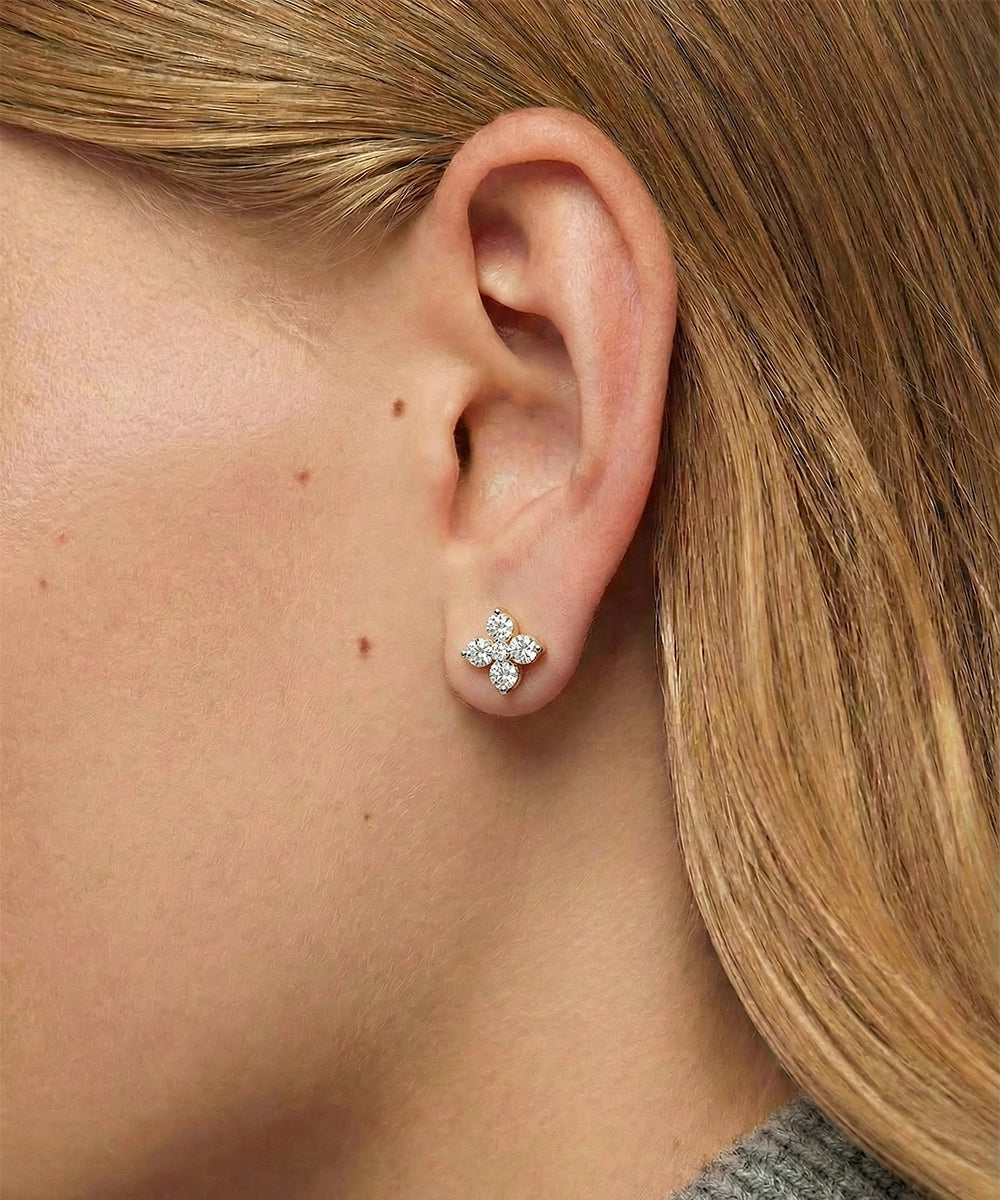 Close-up of a person wearing a diamond earring.