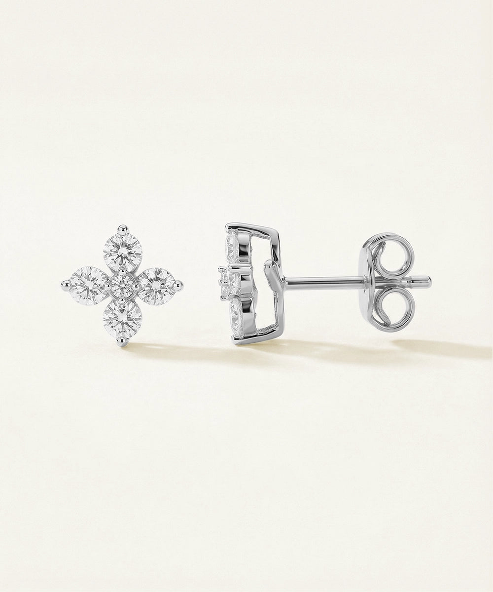 Pair of diamond stud earrings on a light background