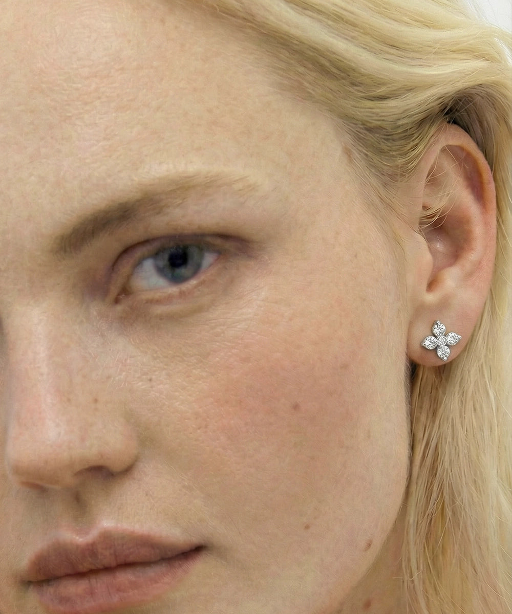 Close-up of a woman wearing a diamond earring.