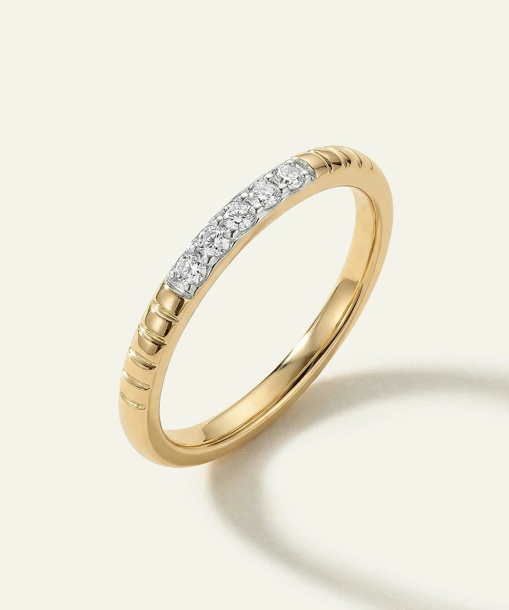 Gold ring with diamonds on a light background