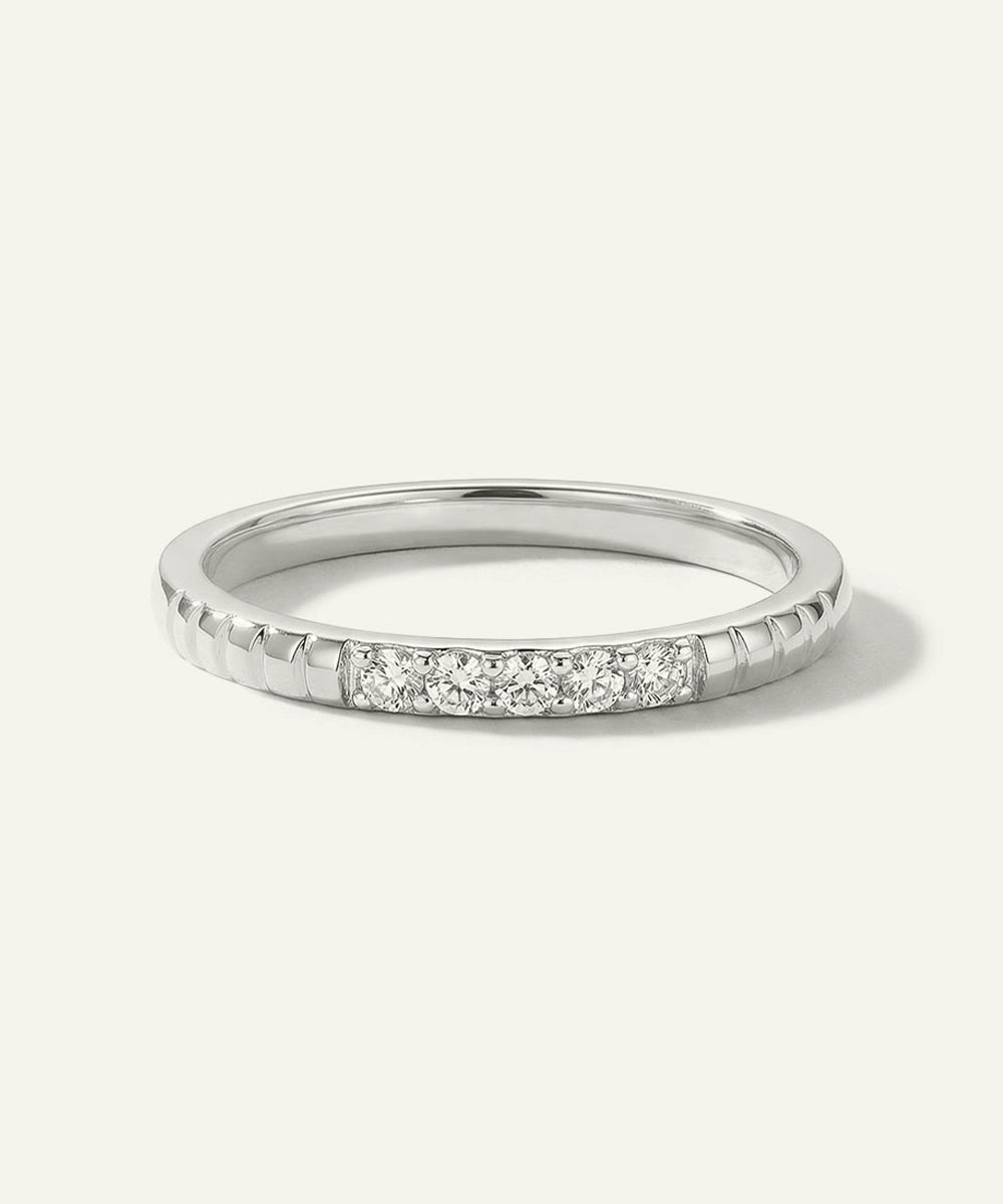 Silver ring with small diamonds on a white background