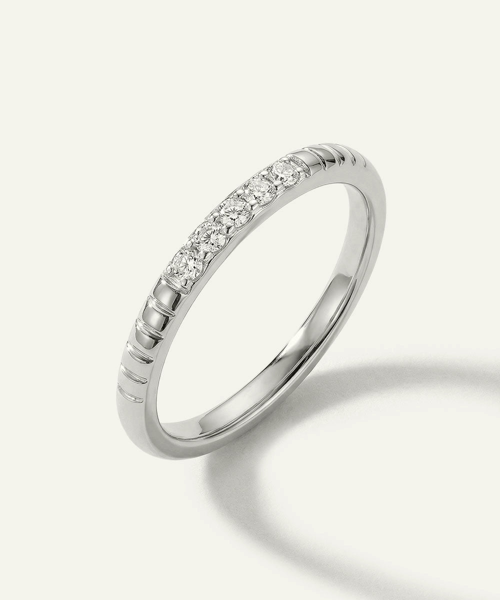 Silver ring with small diamonds on a white background