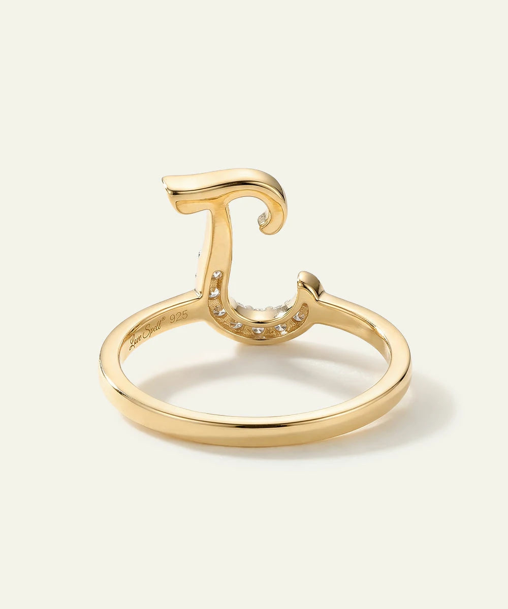 Gold ring with a unique design on a white background