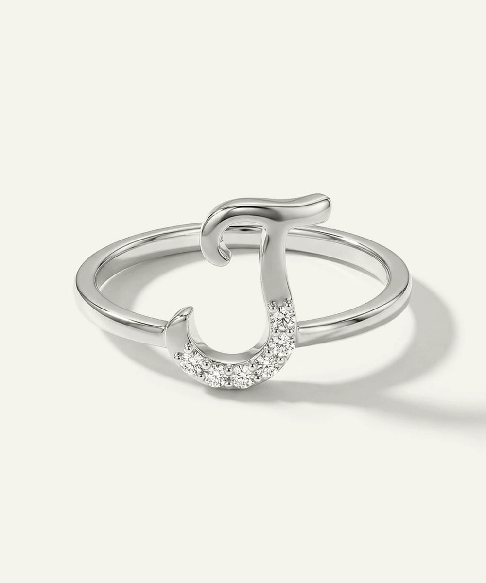 Silver ring with a horseshoe design on a white background