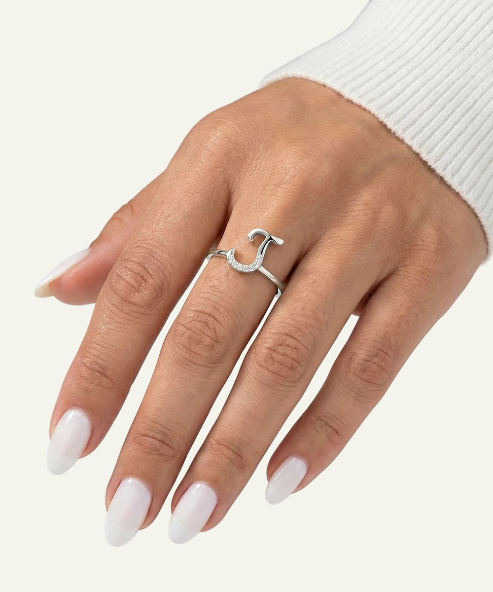 Hand wearing a silver ring with a white background