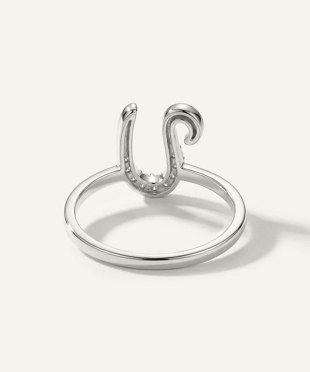 Silver ring with a unique design on a white background