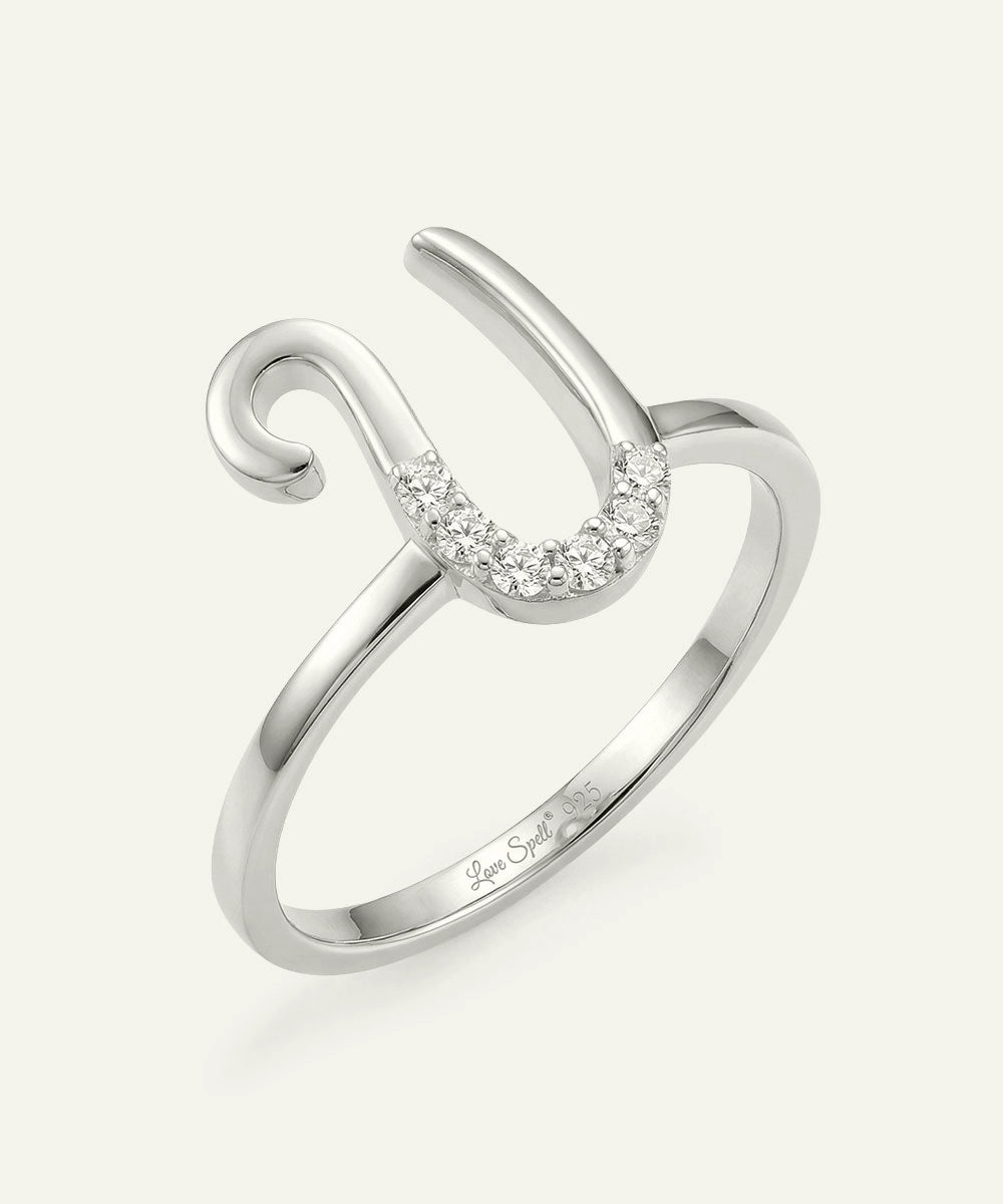 Silver ring with a curved design and small diamonds on a white background