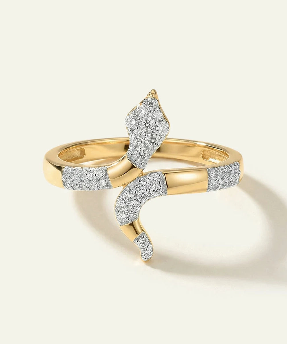 Gold ring with diamond accents on a light background