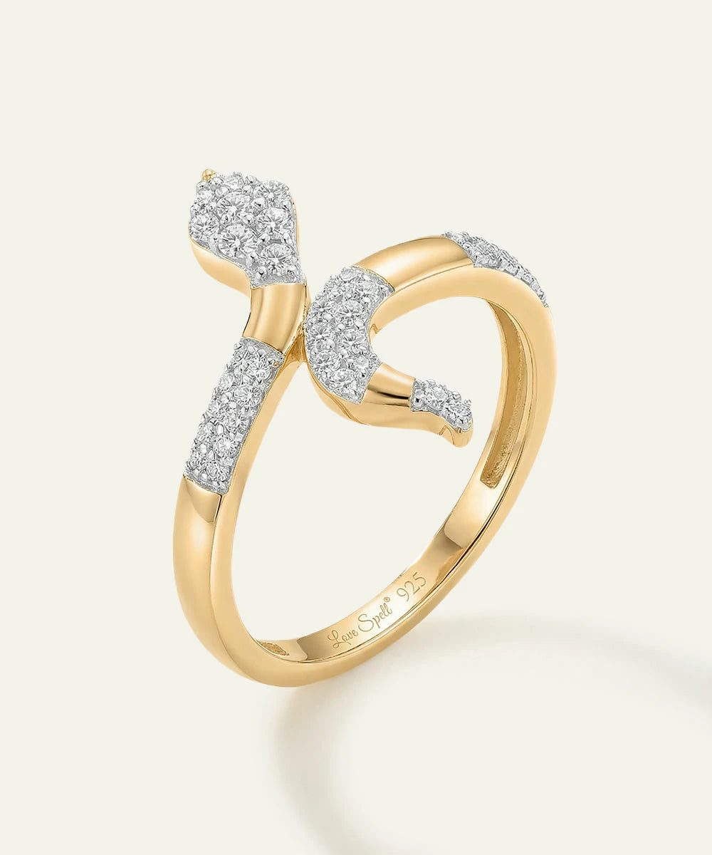Gold ring with diamond accents on a light background