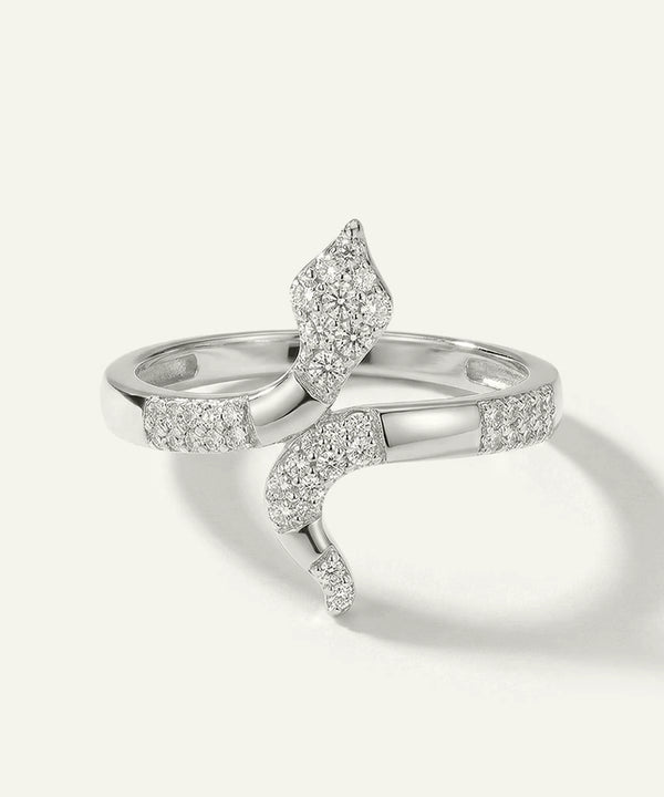 Silver ring with diamond accents on a light gray background