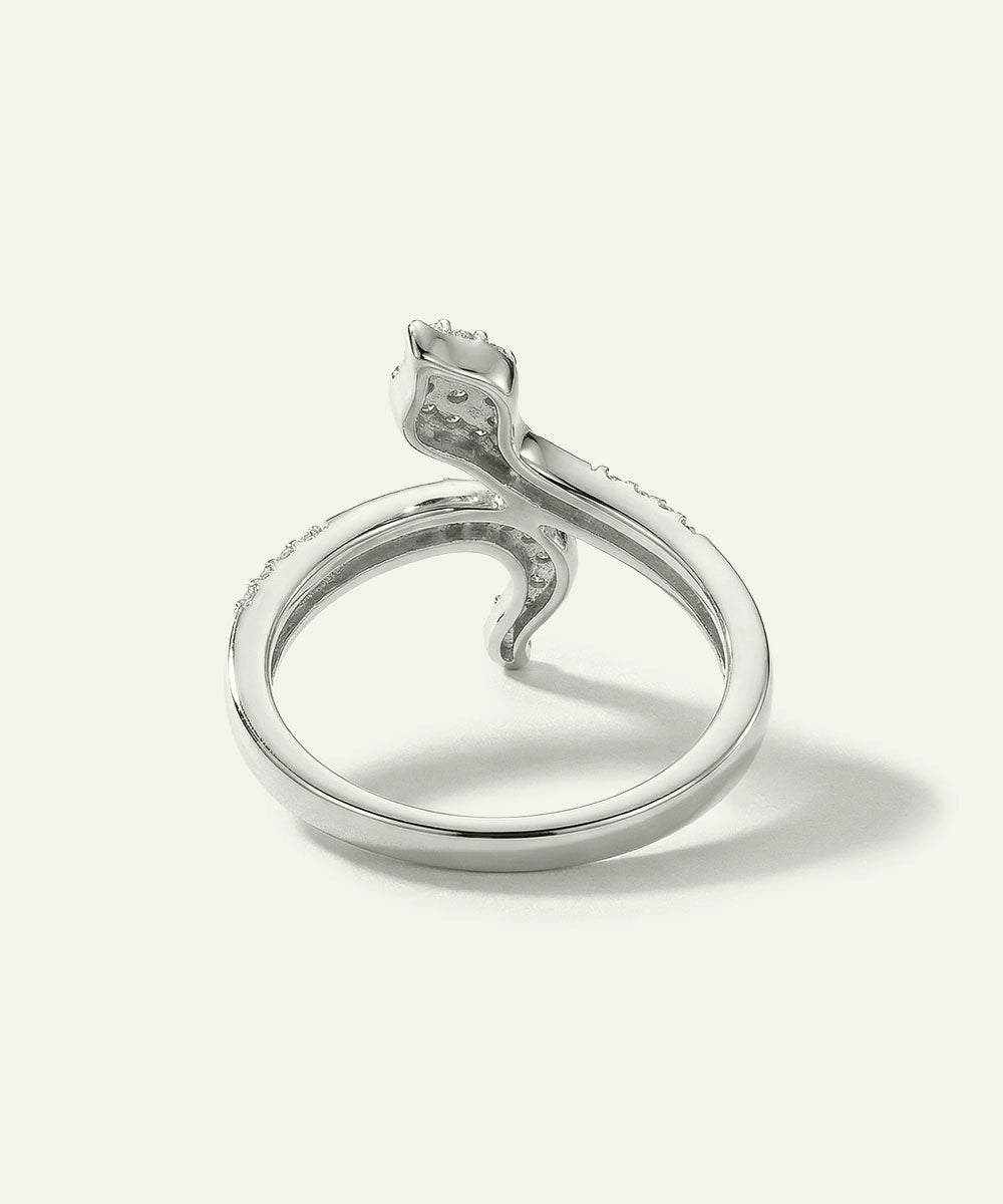 Silver ring with a diamond on a light gray background