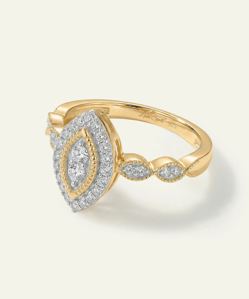 Gold and diamond ring on a light gray background