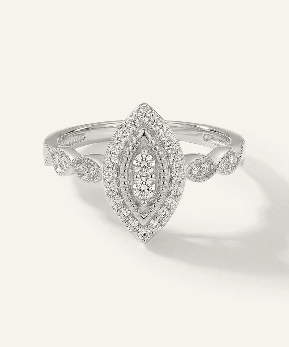 Silver ring with diamond accents on a light gray background