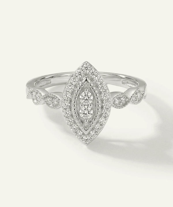 Silver ring with diamond accents on a light gray background