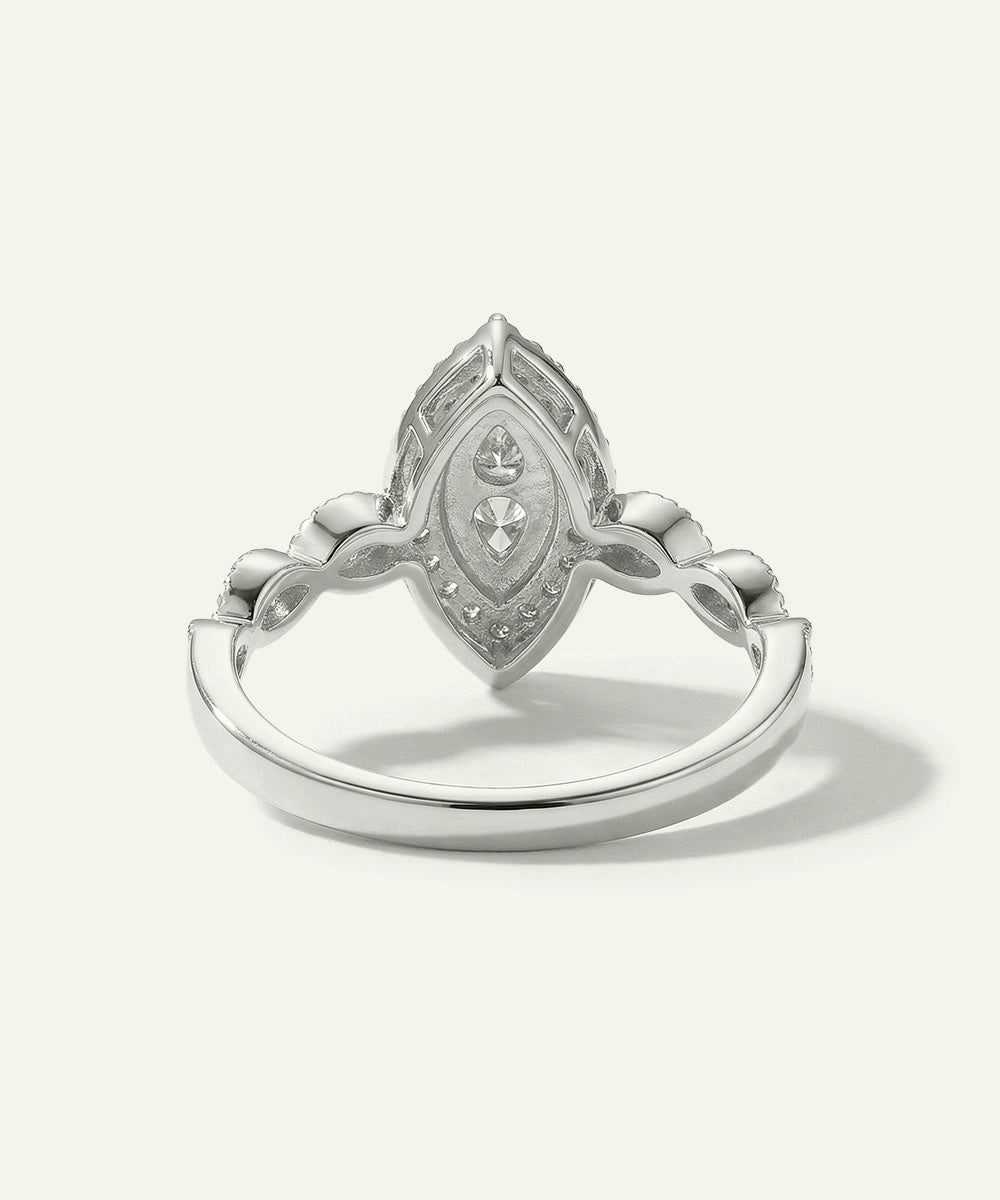 Silver ring with intricate design on a white background