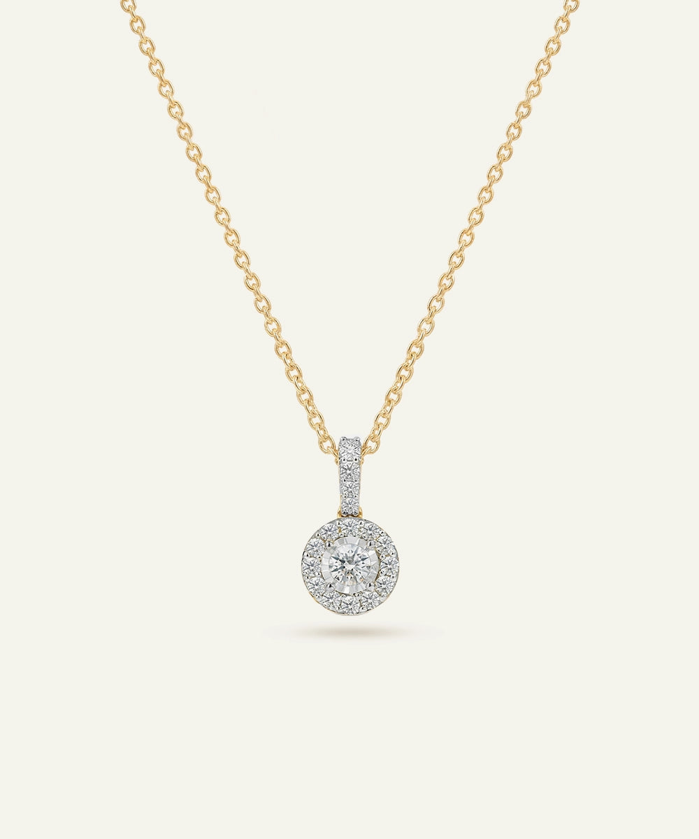 Gold necklace with a diamond pendant on a white background