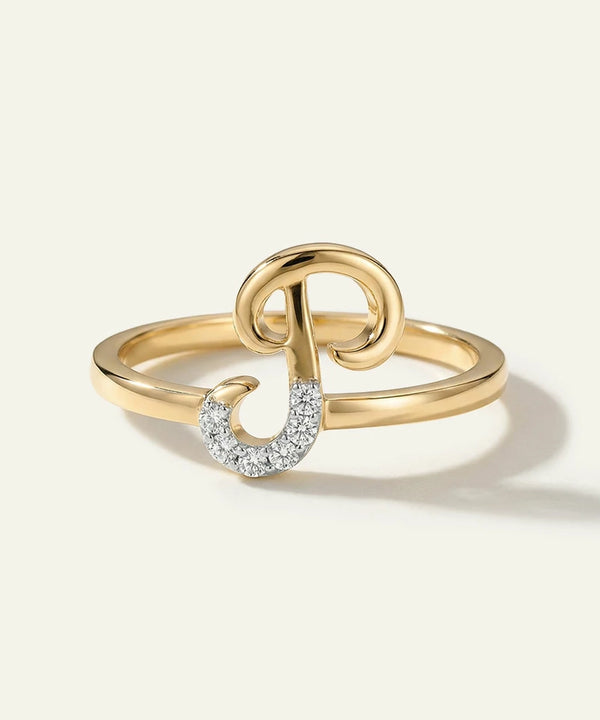 Gold ring with a unique design on a light beige background